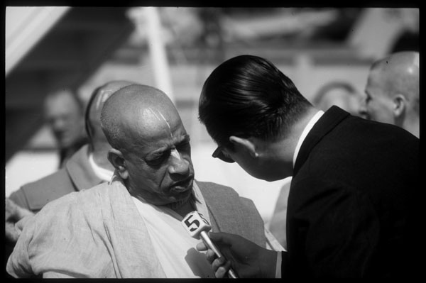 Srila Prabhupada is interviewed by a news reporter